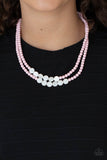 Paparazzi Extended STAYCATION - Pink - Necklace  -  A summery collection of shiny white shell-like discs and dainty light-pink beads are threaded along invisible wires, creating colorful layers below the collar. Features an adjustable clasp closure.

