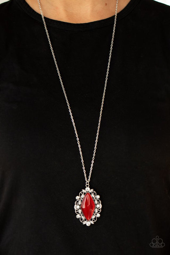 Paparazzi Exquisitely Enchanted - Red - Necklace  -  Dotted in glassy white rhinestones, leafy silver filigree blooms from an oversized red cat's eye stone, creating an enchanted pendant at the bottom of a lengthened silver chain. Features an adjustable clasp closure.
