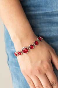 Paparazzi Lustrous Luminosity - Red - Bracelet  -  Featuring sleek silver fittings, an oversized collection of fiery red gems delicately link around the wrist. The centermost gem is slightly larger than the rest, adding a glamorous finish. Features an adjustable clasp closure.
