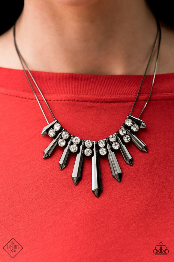 Paparazzi Dangerous Dazzle - Necklace  -  Pairs of glittery white rhinestones alternate between flared gunmetal rods that are threaded along two rows of flat gunmetal chains, creating a dangerously dazzling fringe below the collar. Features an adjustable clasp closure.
