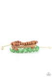 Paparazzi Down HOMESPUN - Green - Bracelet  -  Strands of glassy green cat's eye beads stand out in an earthy collection of wooden beads and braided twine, giving a polished flair to the natural homespun look as it stacks up the wrist. Features an adjustable sliding knot closure.
