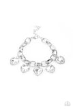 Paparazzi Candy Heart Charmer - White - Bracelet  -  White heart-shaped gems are encased in sleek silver frames that swing from an oversized silver chain, creating a sparkly fringe around the wrist. Features an adjustable clasp closure.
