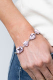 Paparazzi Cosmic Treasure Chest - Pink - Bracelet  -  A collection of oversized round, teardrop, and emerald cut pink rhinestones delicately link around the wrist, creating a blinding statement piece. Features an adjustable clasp closure.
