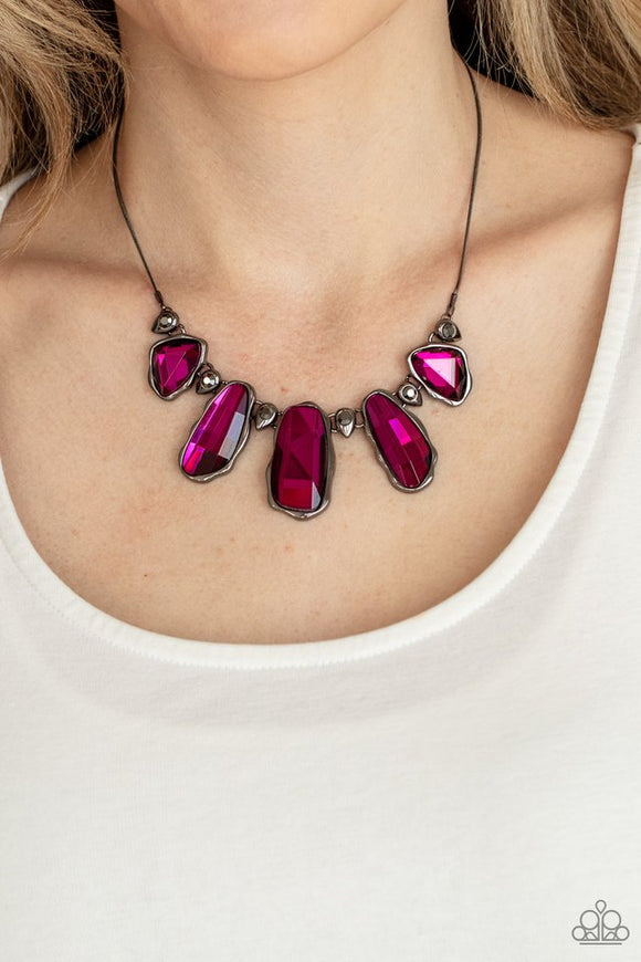 Paparazzi Cosmic Cocktail - Pink - Necklace  -  A glittery collection of raw cut pink gems delicately link with dainty hematite rhinestone dotted gunmetal teardrops below the collar, creating a stellar fringe. Features an adjustable clasp closure.
