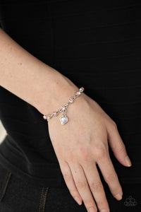 Paparazzi Sweet Sixteen - Pink - Bracelet  -  Brilliant pink rhinestones in shiny silver settings are linked together and accented with a charming iridescent rhinestone heart that dangles sweetly from the wrist. Features an adjustable clasp closure.
