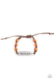 Paparazzi Conversation Piece - Orange - Bracelet  -  A silver plate engraved with the word "FEARLESS" is centered between brown knotted cording. Accented with bright orange stone beads, it slides around the wrist for an unconventional conversation starter. Features an adjustable sliding knot closure.
