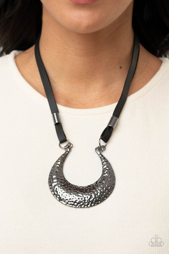 Paparazzi Majorly Moonstruck - Black - Necklace  -  Infused with glistening gunmetal beads, strips of black leather link to an oversized half moon pendant that is hammered in a blinding gunmetal finish, creating an edgy statement piece below the collar. Features an adjustable clasp closure.
