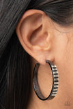 Paparazzi More To Love - Black - Earrings  -  The top half of a thick textured gunmetal frame is lined in a stack of emerald cut white rhinestones, creating an unexpected pop of shimmer. Earring attaches to a standard post fitting. Hoop measures approximately 1 3/4 in diameter.
