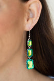 Paparazzi Cosmic Red Carpet - Green - Earrings  -  Featuring a dazzling green and gold UV shimmer, a trio of emerald-cut gems in graduating sizes is linked one below the other for a dramatic red carpet finish. Earring attaches to a standard fishhook fitting.
