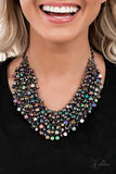 Paparazzi Vivacious - 2021 Zi Signature Collection  -  Fiercely faceted oil spill beads flawlessly cascade from row after row of boldly interlocking gunmetal links that connect into an intense metallic netted backdrop. Attached to matching chunky gunmetal chains, the effervescently edgy display noisily swishes back and forth, creating an out-of-this-world fringe below the collar. Features an adjustable clasp closure.
