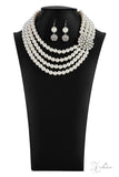 Paparazzi Romantic - 2021 Zi Signature Collection  -  Inspired by royalty, an elegant explosion of classic white rhinestones and timeless pearls delicately coalesces into a vintage brooch. The refined ornament delicately holds together strands of oversized pearls, creating romantically regal layers below the collar. Features an adjustable clasp closure.
