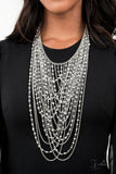 Paparazzi Enticing - 2021 Zi Signature Collection  -  An entrancing collection of raw cut, faceted, and crystal-like silver and hematite beads delicately connect into glitzy strands that dauntlessly drape across the chest. Intermixed with plain silver chains, the swooping layers sway with every movement, creating an audaciously audible shimmer. Features an adjustable clasp closure.
