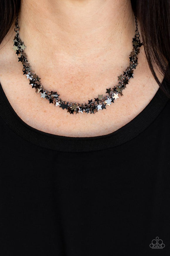 Paparazzi Starry Anthem - Black - Necklace  -  A glistening collection of dainty gunmetal star charms delicately cluster on a classic gunmetal chain, creating a stellar fringe below the collar. Features an adjustable clasp closure.
