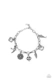 Paparazzi Fancifully Flighty - White - Bracelet  -  White gems, a floral medallion, a bird in flight, and a fluttering feather coalesce into a whimsical charm bracelet as they dangle from a delicate silver chain around the wrist. Features an adjustable clasp closure.
