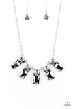 Paparazzi Celestial Royal - Silver - Necklace  - 2021 Convention Exclusive  -  Featuring classic pronged fittings, a dramatic collection of oversized smoky rhinestones and emerald cut hematite gems fan out below the collar for an outrageous sparkle. Features an adjustable clasp closure.
