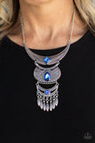 Paparazzi Lunar Enchantment - Blue - Necklace  - 2021 Convention Exclusive  -  Embossed in studded, geometric, and paisley filigree-like patterns, three mismatched silver half moon plates dramatically link below the collar. Featuring an entrancing blue UV shimmer, an oversized collection of square, teardrop, and round rhinestones embellish the decorative silver frames, while a silver beaded fringe swings from the lowermost plate for a noisemaking finish. Features an adjustable clasp closure.
