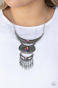 Paparazzi Lunar Enchantment - Multi - Necklace  -  Embossed in studded, geometric, and paisley filigree-like patterns, three mismatched silver half moon plates dramatically link below the collar. Featuring an iridescent UV shimmer, an oversized collection of square, teardrop, and round rhinestones embellish the decorative silver frames, while a silver beaded fringe swings from the lowermost plate for a noisemaking finish. Features an adjustable clasp closure.
