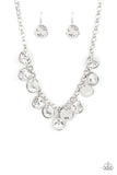 Paparazzi Spot On Sparkle - White - Necklace  - 2021 Convention Exclusive  -  A blinding collection of hammered silver discs and oversized white gems swing from the bottom of a bold silver chain, creating noise-making sparkle below the collar. Features an adjustable clasp closure.
