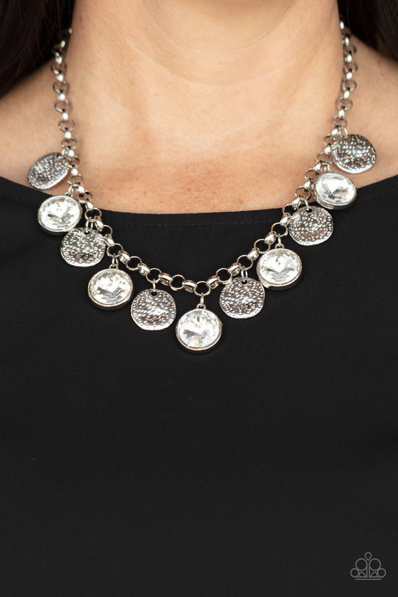 Paparazzi Spot On Sparkle - White - Necklace  - 2021 Convention Exclusive  -  A blinding collection of hammered silver discs and oversized white gems swing from the bottom of a bold silver chain, creating noise-making sparkle below the collar. Features an adjustable clasp closure.
