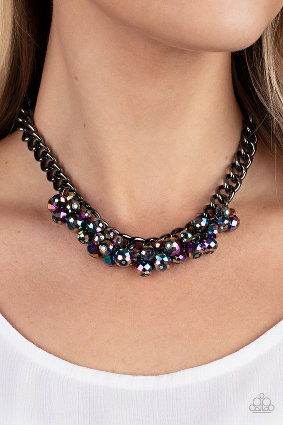 Paparazzi Galactic Knockout - Multi - Necklace  -  Flecked in oil spill iridescence, a faceted collection of metallic beads cluster along the center of a chunky gunmetal curb chain, creating a stellar fringe below the collar. Features an adjustable clasp closure.
