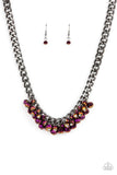 Paparazzi Galactic Knockout - Purple - Necklace  -  Flecked in oil spill iridescence, a faceted collection of metallic purple beads cluster along the center of a chunky gunmetal curb chain, creating a stellar fringe below the collar. Features an adjustable clasp closure.
