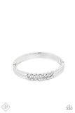 Paparazzi Doubled Down Dazzle - White - Bracelet  -  Stacked layers of brilliant white rhinestones give way to double layers of sleek silver frames that feature a subtle wave, creating a dramatically modern design around the wrist. Features a hinged closure.

