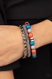 Paparazzi Tour de Tourist - Multi - Bracelet  -  A mismatched collection of silver discs, silver cubes, bubbly multicolored acrylic, and silver pebble-like beads are threaded along stretchy bands around the wrist, creating fiery layers.
