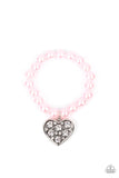 Paparazzi Cutely Crushing - Pink - Bracelet  -  A dramatically oversized white rhinestone encrusted silver heart charm dangles from a stretchy strand of bubbly pink pearls, creating a flirtatious dazzle.
