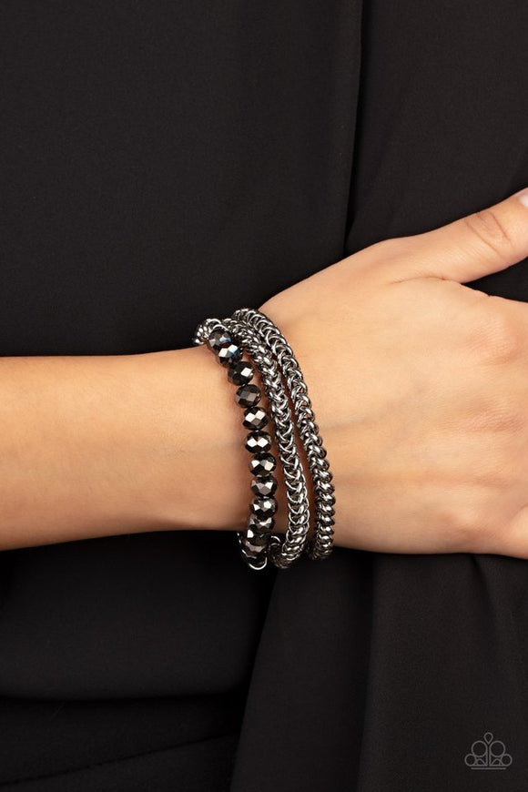 Paparazzi Gutsy and Glitzy - Silver - Bracelet  -  Threaded along stretchy bands, sections of hematite crystal-like beads and interlocking silver chains layer around the wrist for a dash of glitzy grunge.
