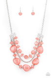 Paparazzi Oceanside Service - Pink - Necklace  -  A single silver chain separates two mismatched rows of oversized and cloudy glass-like pink beads. The colorful rows are held in place with textured silver fittings, creating an ethereal pop of color below the collar. Features an adjustable clasp closure.
