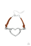 Paparazzi Flirty Flavour - Brown - Set  -  Strands of brown suede knot around sections of chunky silver chains that have been adorned in an oversized silver heart frame, resulting in a flirtatious display around the wrist. Features an adjustable clasp closure.