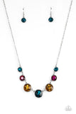 Paparazzi Pampered Powerhouse - Multi - Necklace  -  Encased in shiny silver frames, a glitzy collection of blue, yellow, and pink rhinestones gradually increase in size as they link below the collar for a flawless finish. Features an adjustable clasp closure.

