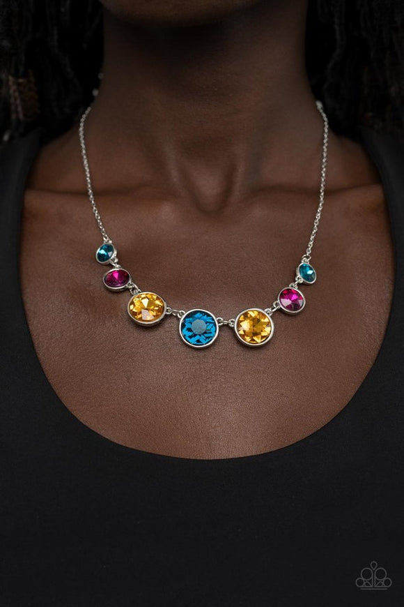 Paparazzi Pampered Powerhouse - Multi - Necklace  -  Encased in shiny silver frames, a glitzy collection of blue, yellow, and pink rhinestones gradually increase in size as they link below the collar for a flawless finish. Features an adjustable clasp closure.
