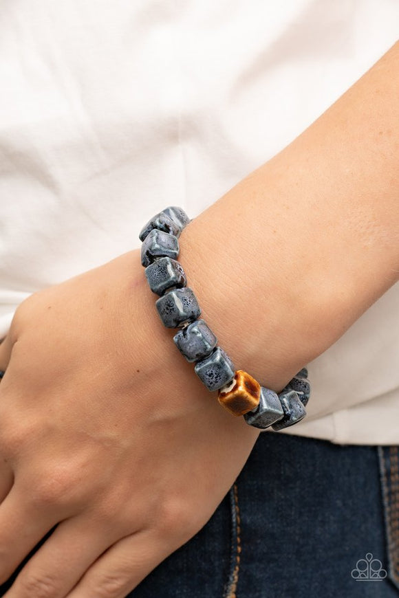 Paparazzi Glaze Craze - Blue - Bracelet  -  Featuring distressed blue and brown glazed finishes, a rustic collection of ceramic cube beads are threaded along stretchy bands around the wrist for a colorful flair.
