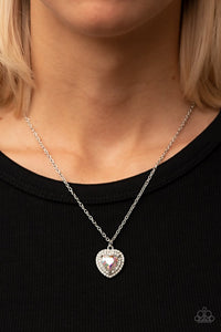 Paparazzi Taken with Twinkle - Multi - Necklace  -  Bordered in stacked rows of glassy white rhinestones, a twinkly iridescent heart shaped gem sparkles at the center of a dainty silver chain for a flirtatious fashion. Features an adjustable clasp closure.
