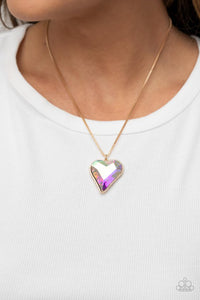 Paparazzi Lockdown My Heart - Gold - Necklace  -  An iridescent heart-shaped gem is pressed into a simple gold frame at the end of a gold box chain creating an adorable sentiment below the collar. Features an adjustable clasp closure.
