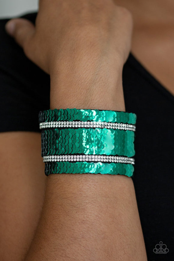 Paparazzi MERMAID Service - Green
Infused with strands of blinding white rhinestones, row after row of shimmery sequins are stitched across the front of a spliced black suede band. Bracelet features reversible sequins that change from silver to green. Features an adjustable snap closure.
