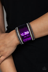 Paparazzi MERMAIDS Have More Fun - Purple
Shiny silver studs, glassy white rhinestones, and shimmering sequins are sprinkled across a thick black suede band that has been spliced into five glittery rows. Bracelet features reversible sequins that change from purple to silver. Features an adjustable snap closure.
