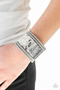 Paparazzi MERMAIDS Have More Fun - Silver
Shiny silver studs, glassy white rhinestones, and shimmering sequins are sprinkled across a thick gray suede band that has been spliced into five glittery rows. Bracelet features reversible sequins that change from silver to silver. Features an adjustable snap closure.
