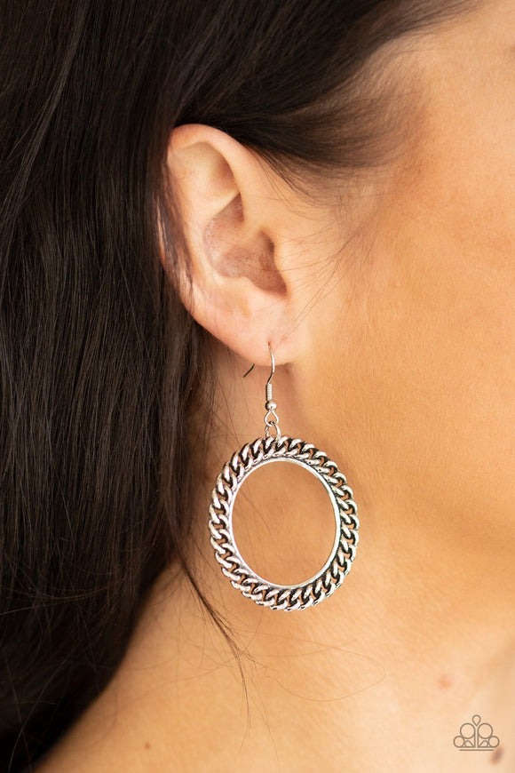 Paparazzi Above The Rims - Silver - Earrings
An edgy strand of silver chain wraps around a silver ring, coalescing into a bold industrial hoop. Earring attaches to a standard fishhook fitting.
