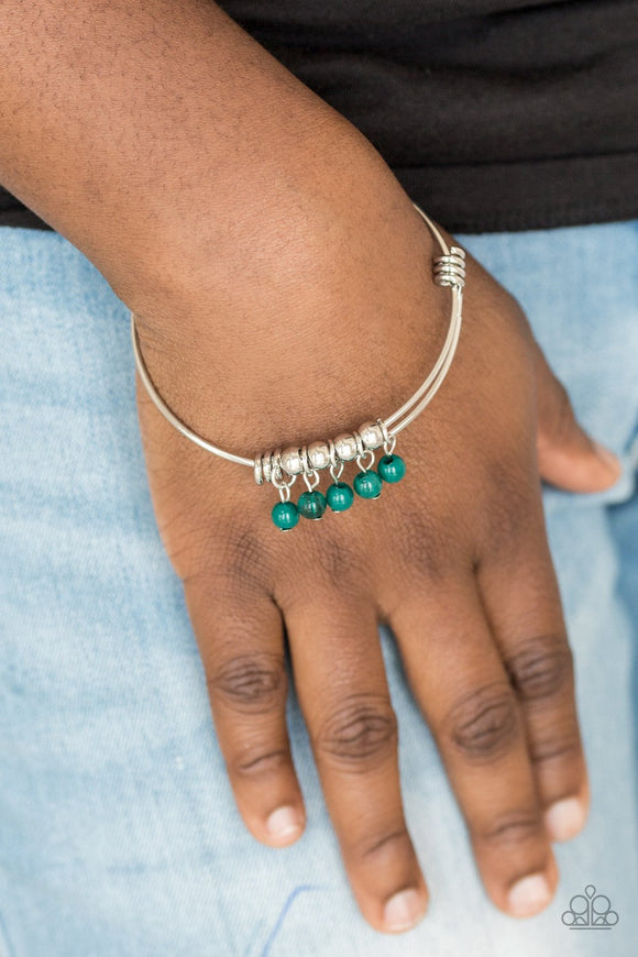 Paparazzi All Roads Lead To ROAM - Green - Bracelet
Silver wire coils around the wrist, creating an adjustable-like bangle. Polished green beads slide between two wire wrap fittings, creating colorful accents along the wrist.
