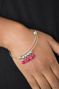 Paparazzi All Roads Lead To ROAM - Pink - Bracelet
Silver wire coils around the wrist, creating an adjustable-like bangle. Glassy pink beads slide between two wire wrap fittings, creating colorful accents along the wrist. 