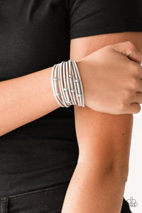 Paparazzi Back To Backpacker - Silver - Bracelet
Strung between two silver fittings, glistening silver and gunmetal accents slide along strands of gray suede for a seasonal look. Features an adjustable clasp closure.
