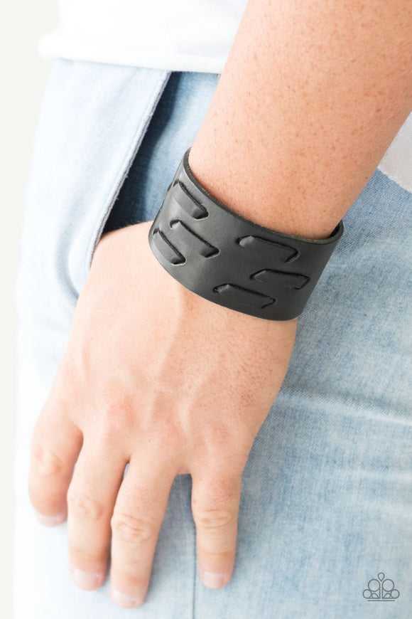Paparazzi Be Your Own HUNTSMAN - Black - Bracelet
Black leather cording is laced across the front of a thick leather band, creating a rugged look around the wrist. Features an adjustable snap closure.
