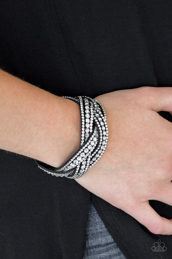 Paparazzi Bring On The Bling - Black - Bracelet
Varying in size, glassy white rhinestones are encrusted along interwoven black suede bands, creating blinding shimmer across the wrist. Features an adjustable snap closure.
