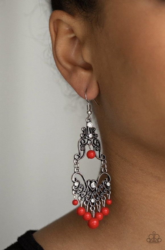 Paparazzi Colorfully Cabaret - Red - Earrings
Infused with hints of glittery white rhinestones, dotted silver filigree swirls into a decorative frame. Polished red beads swing from the bottom and top of the ornate frame, adding colorful movement to the whimsical piece. Earring attaches to a standard fishhook fitting.