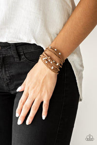 Paparazzi Colorfully Coachella - White - Bracelet
Dainty white wooden beads and classic silver beads are threaded along strands of brown suede, creating colorful layers across the wrist. Features an adjustable clasp closure. 
