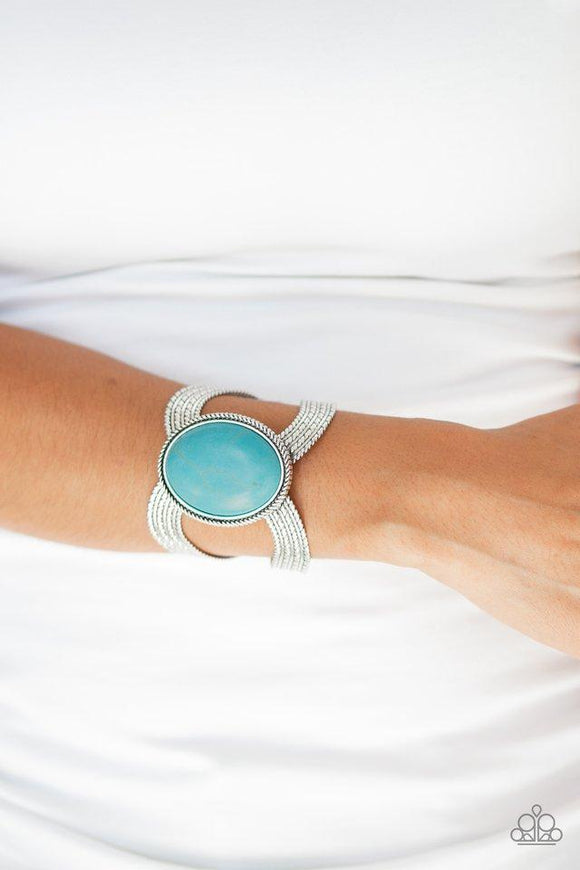 Paparazzi Coyote Couture - Blue - Bracelet
A dramatic turquoise stone pendant is pressed into the center of textured silver bars, creating a bold seasonal cuff. 

