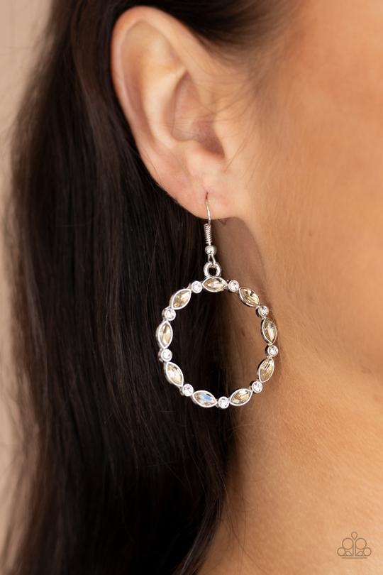 Paparazzi Crystal Circlets - Brown - Earrings
Encased in sleek silver frames, dainty white rhinestones and smoked topaz marquise gems delicately connect into a glittery hoop for a glamorous finish. Earring attaches to a standard fishhook fitting.
