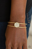 Paparazzi Dial Up The Dazzle - Gold - Bracelet
Glittery white rhinestones are encrusted along the front of a shimmery gold disc atop the center of a dainty gold cuff for a dazzling look. 